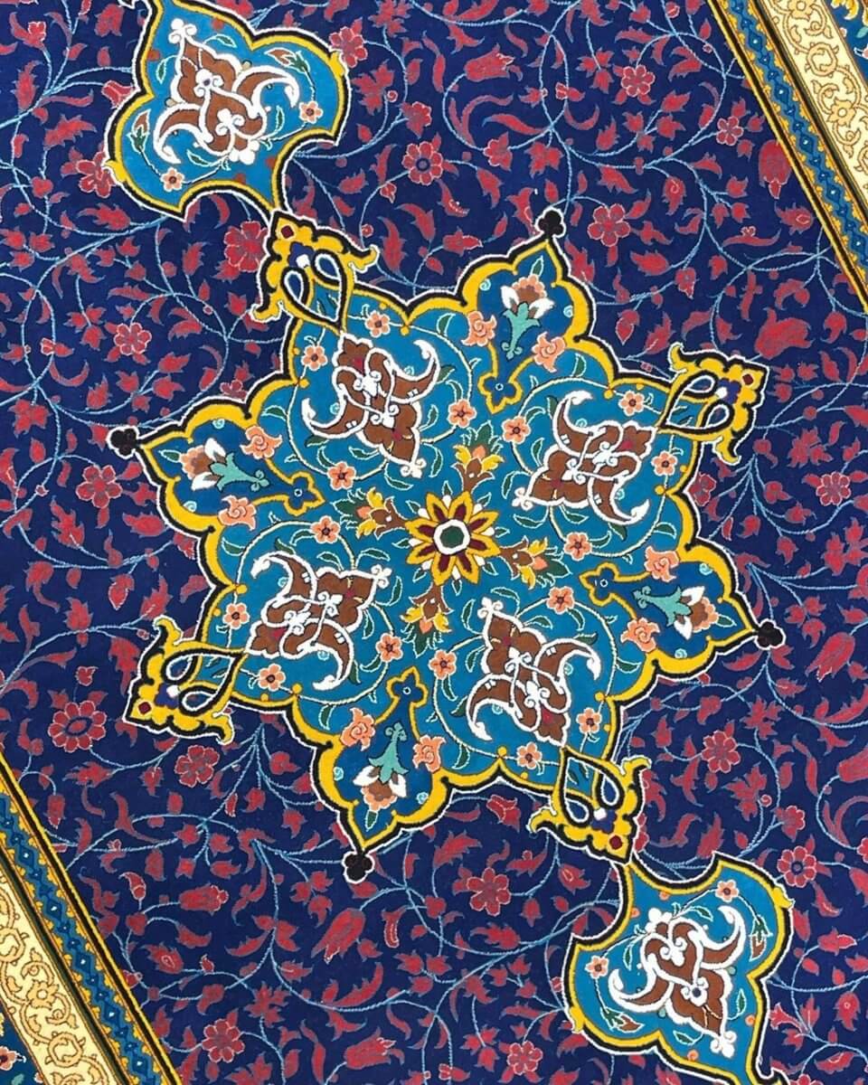 "Close-up of intricate floral medallion on Haghighie collector rug"